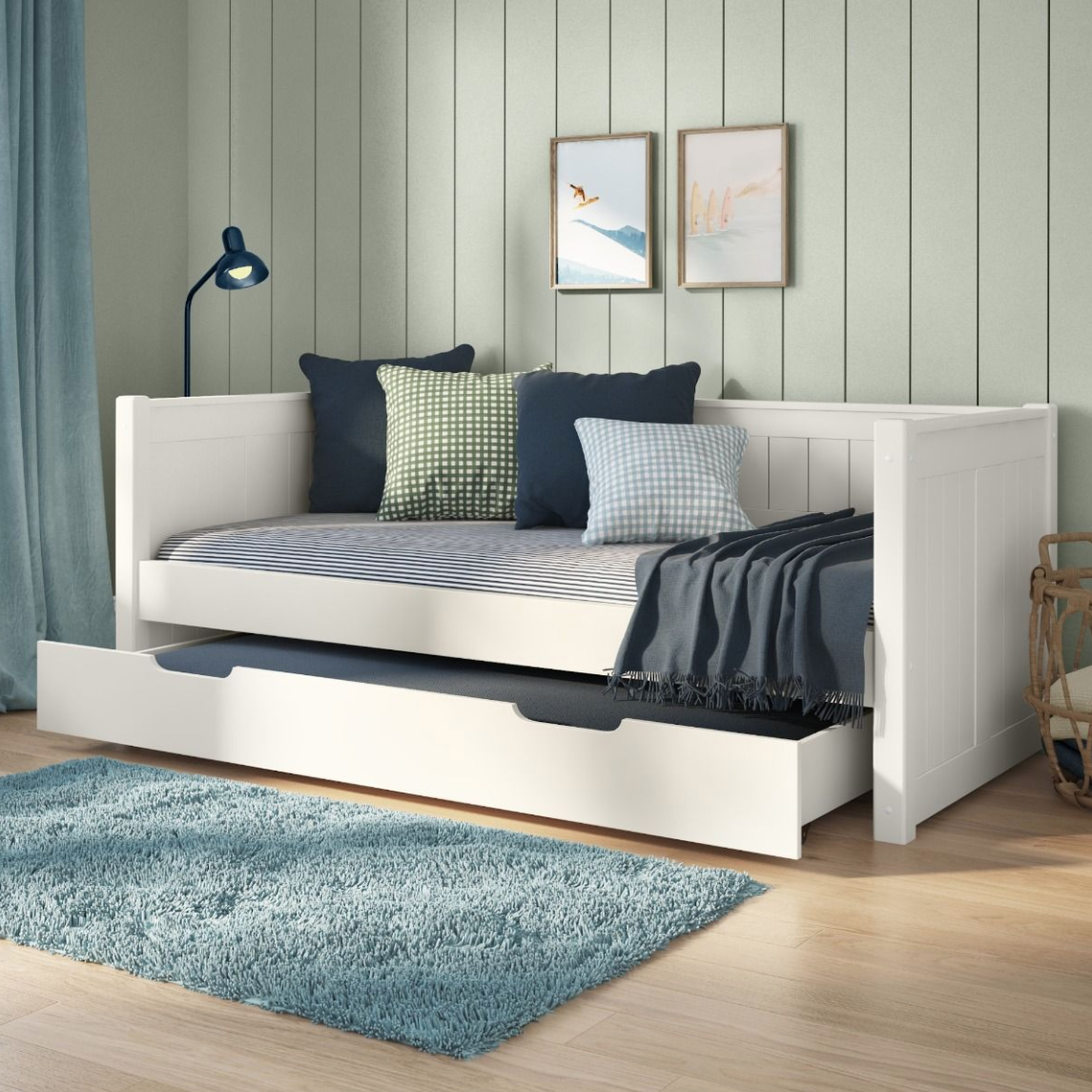 White wooden daybed with tongue and groove features and a pull out trundle bed with mattress for sleepovers